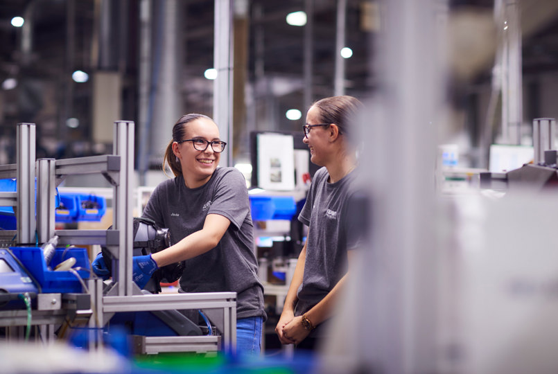 Two employees working on a production line