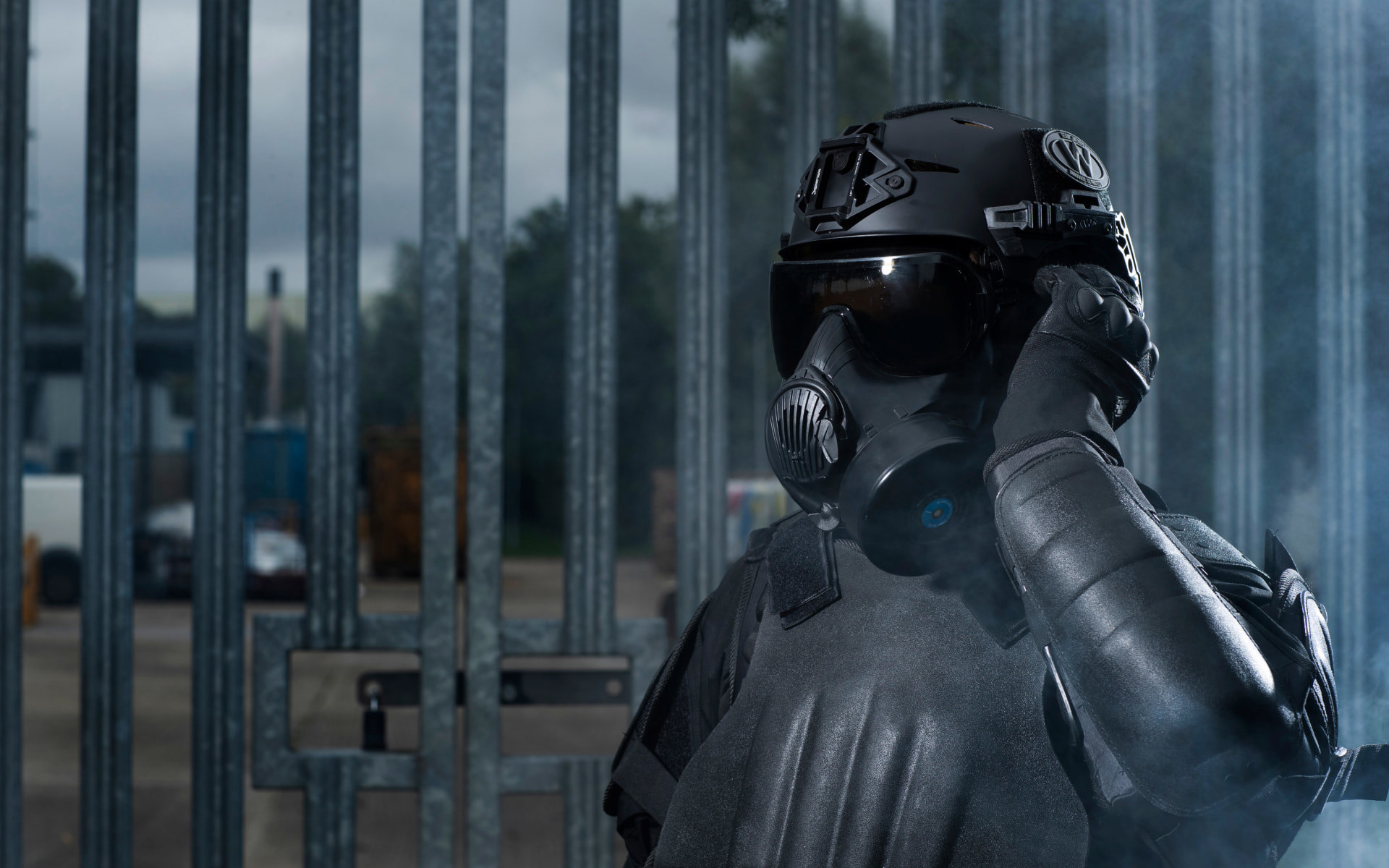 Police officer wearing riot vest, helmet and respirator