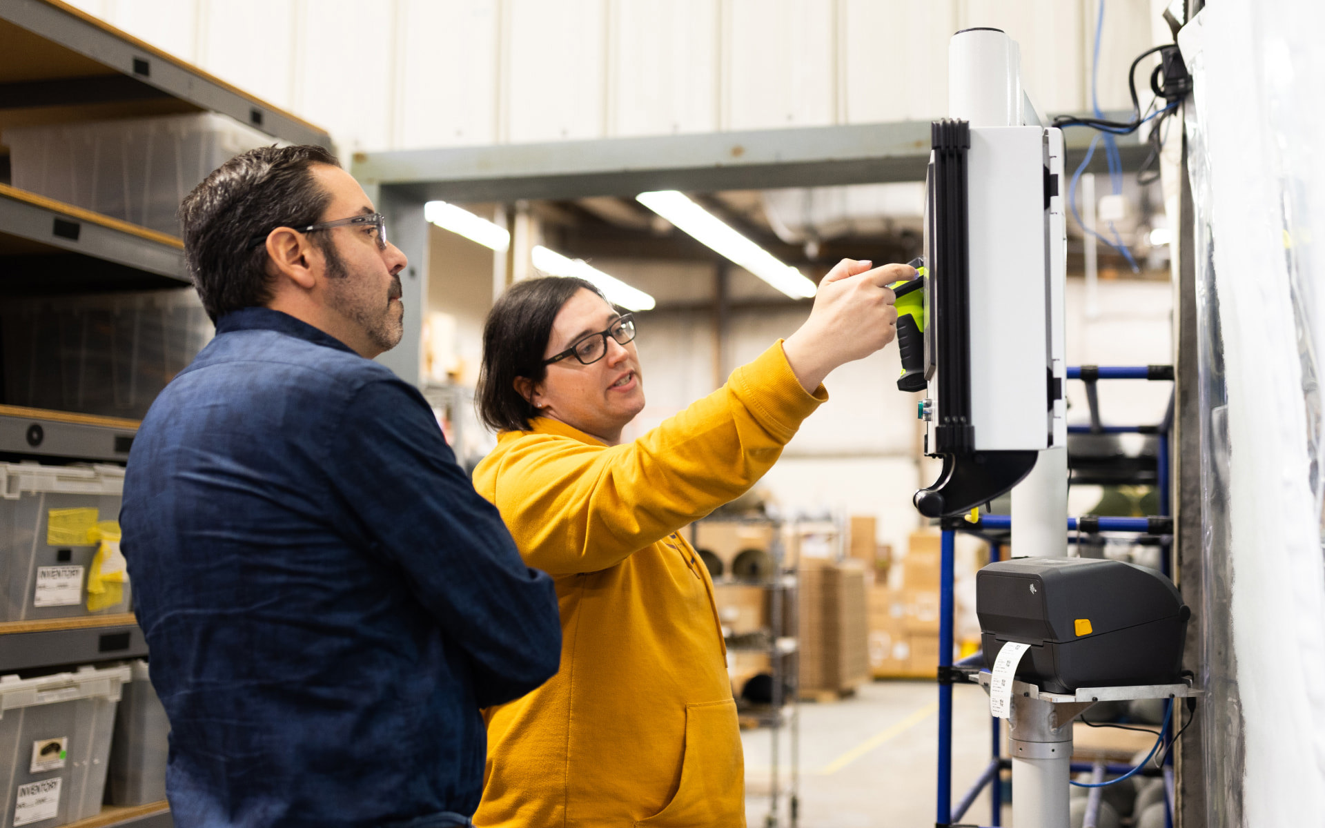 Two employees gathered around a screen